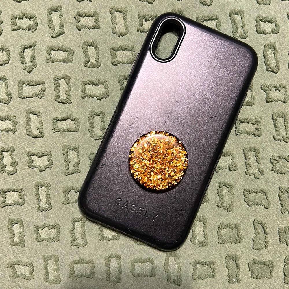 Black IPhone XR case with rose gold pop socket used has minor wear on edges